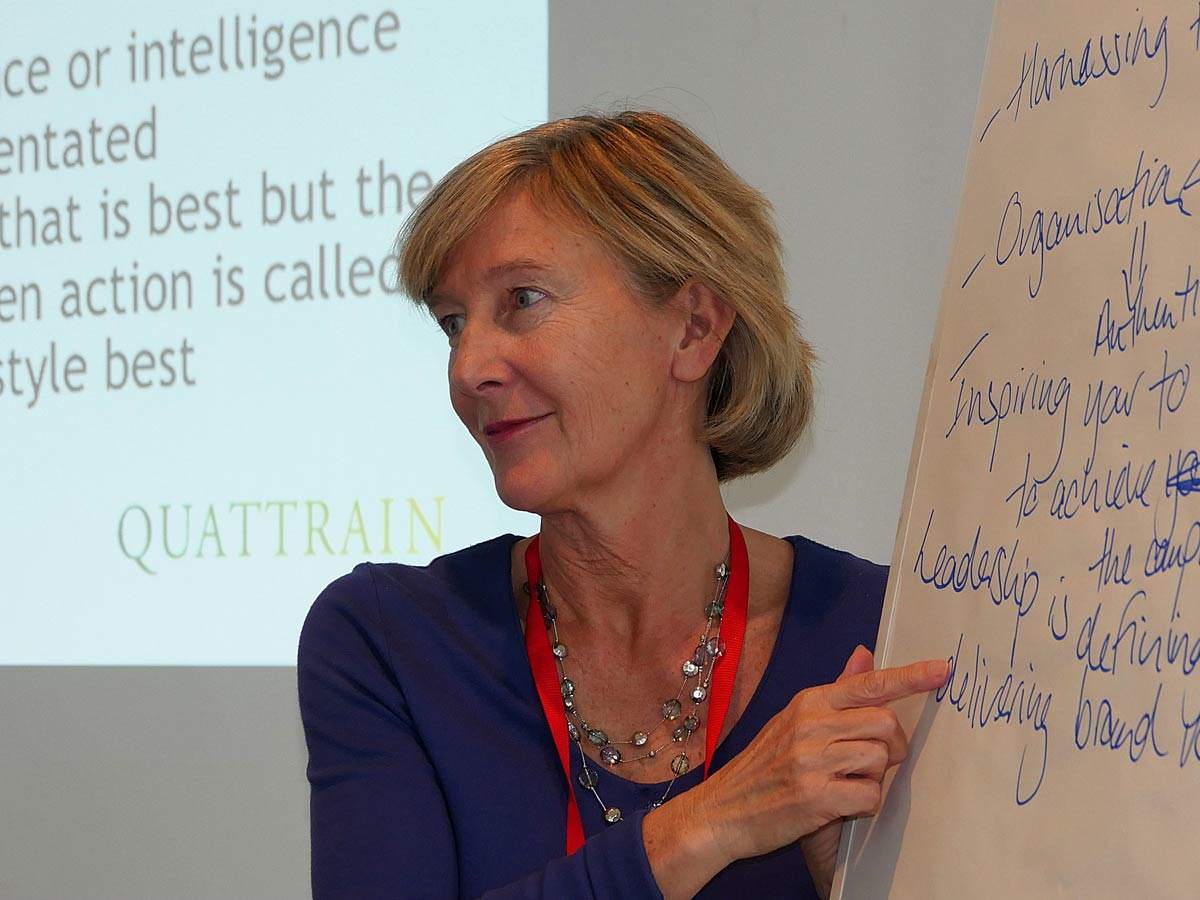 Caroline in front of whiteboard making notes