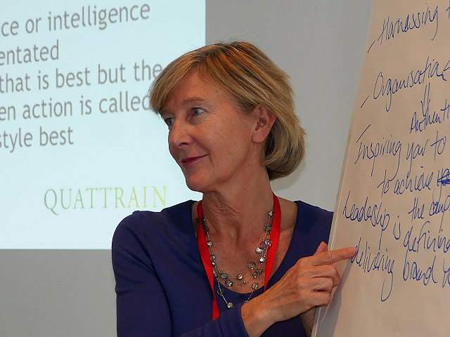 Caroline in front of whiteboard making notes