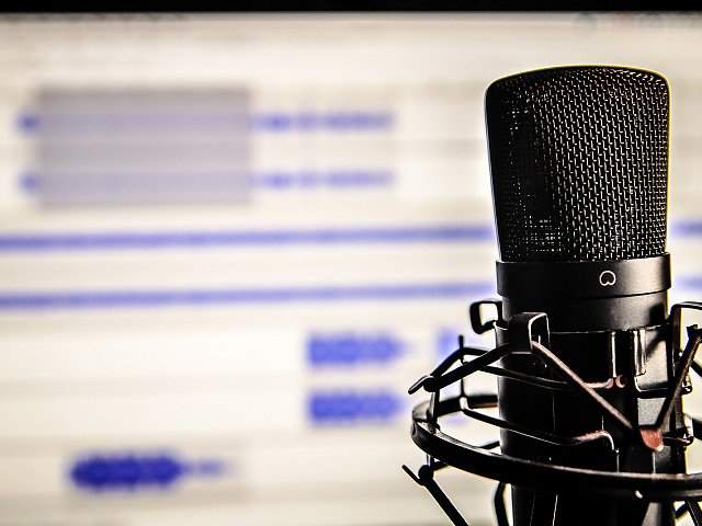 Microphone and audio editing software in background